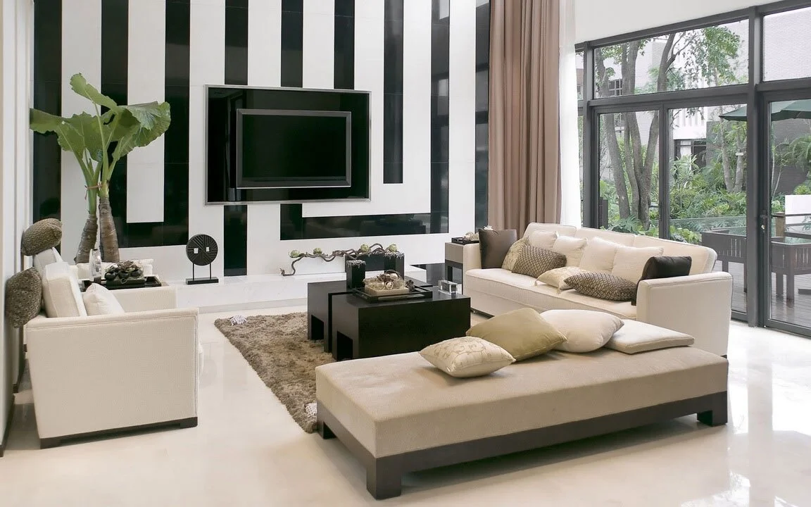 Cool Living Room With Striped Black And White Wall Decor Cream White Sectional Sofa Wooden Small Coffee Table Glass Windows And Door Fur Rug Pot Plant In Creativity In Combining Elements Of Color In Living Room Design Ideas Black And White