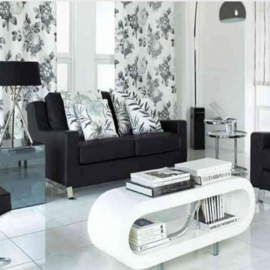 Interior Small Living Design Ideas With Ceramics Floor And White Wall Color Also Black Sofas And Floral Pattern Cushions Also White Book Shelves And Side Tables Also Table Lamps And Casement Glass Win Pertaining To Design Ideas With Black Sofa